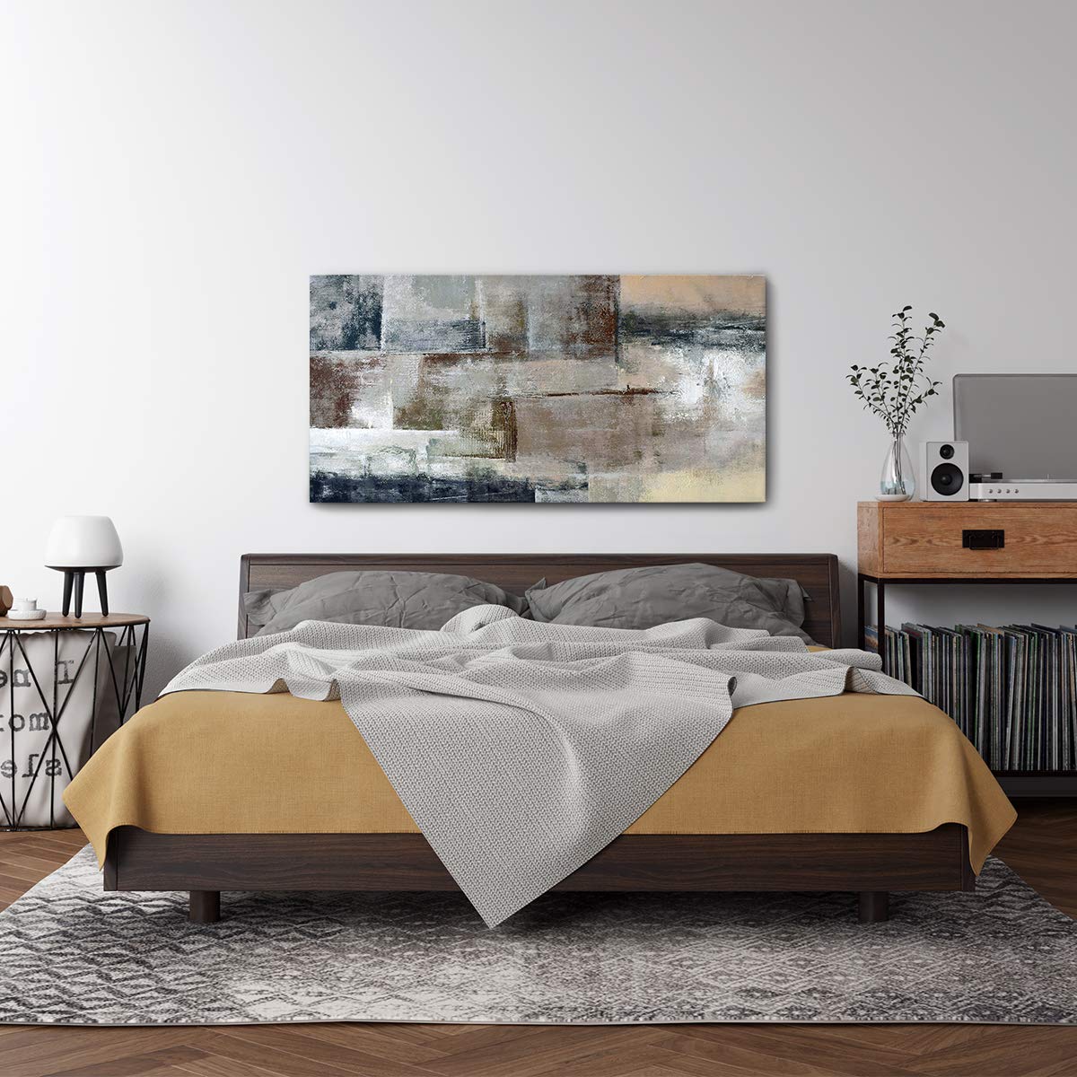 One large statement piece beats three small mismatched frames every time. Aim for art roughly two-thirds the width of the bed.